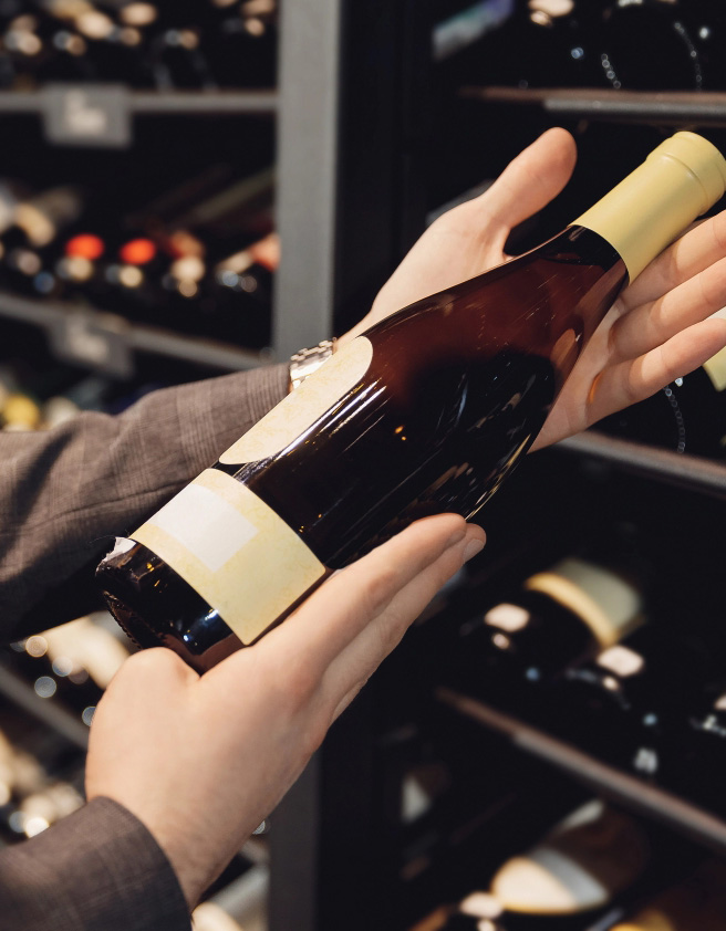 Holding Bottle of Red Wine